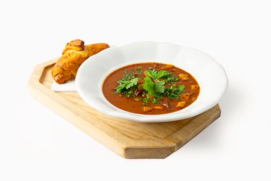 Goulash soup served
with a roll with greaves